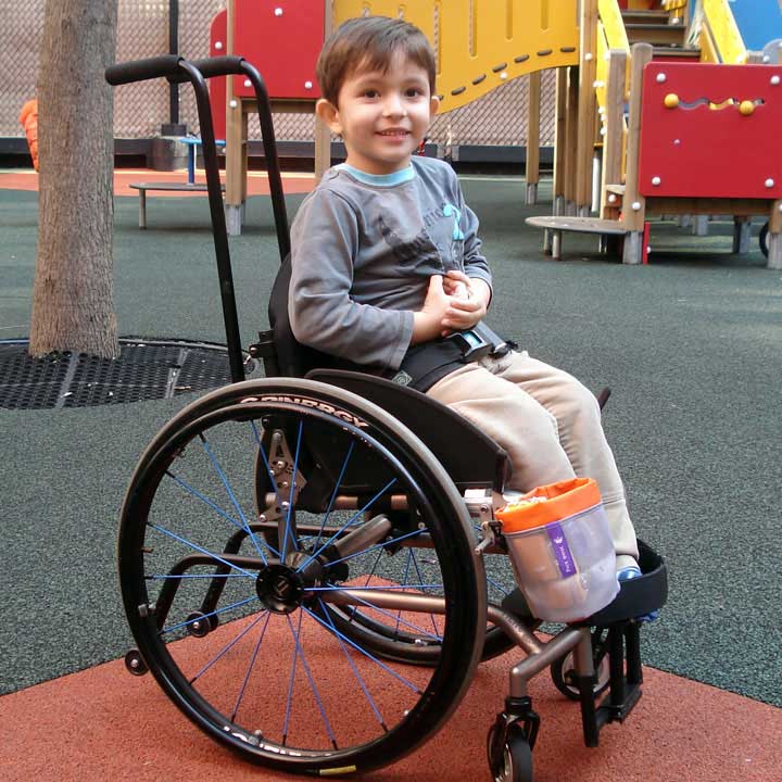 Think King cup holder attached to a boy's wheelchair