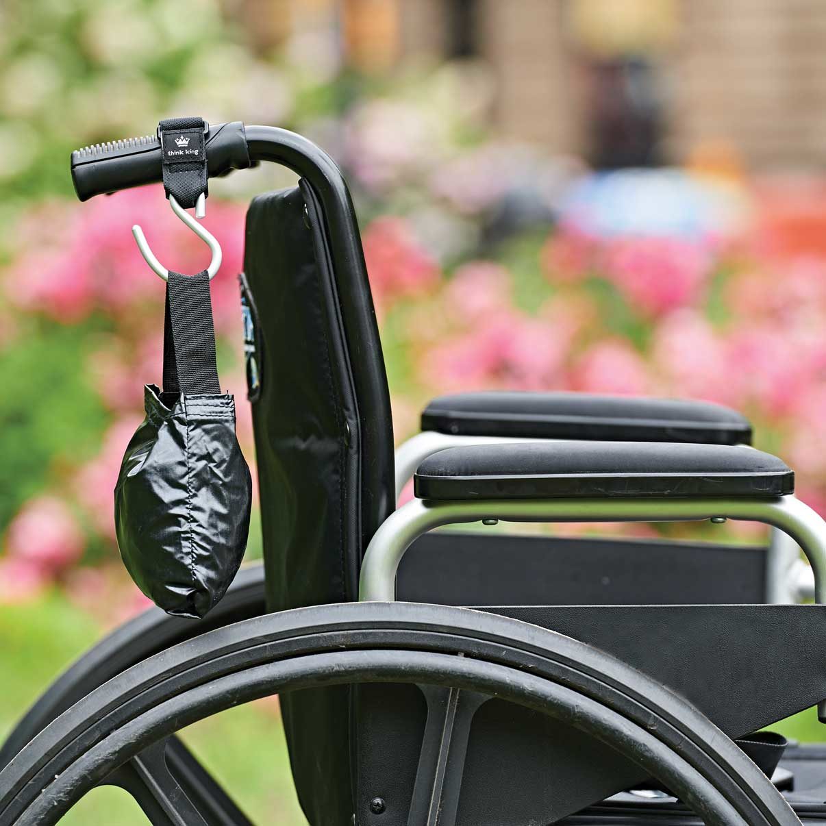 Folded bag on Mighty buggy hook attached to a wheelchair handle
