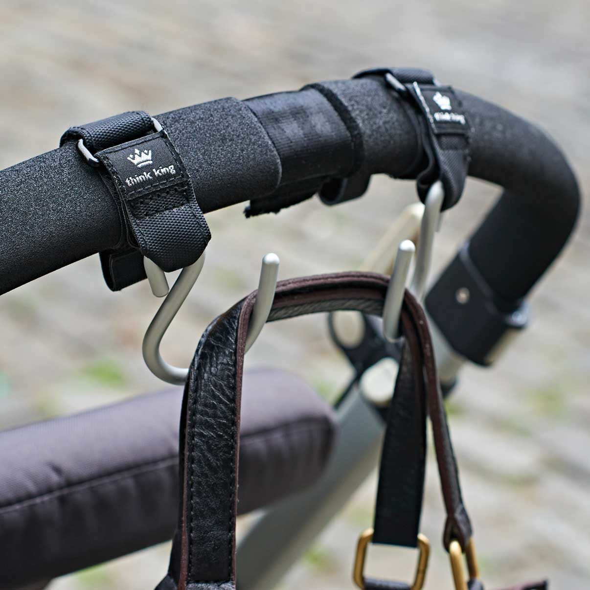 Two Think King Mighty Buggy hooks holding bags on stroller bar